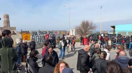 People demonstrate in the area in front of the old lighthouse following the construction of a fence that limits access to the beach in front of the historic fishing platforms, in Fiumicino near Rome.
