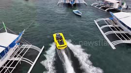 Tourists ride speedboat jetcar off island in the Philippines