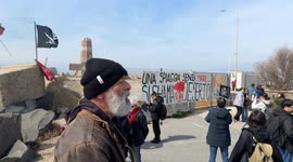 People demonstrate in the area in front of the old lighthouse following the construction of a fence that limits access to the beach in front of the historic fishing platforms, in Fiumicino near Rome.