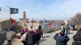 People demonstrate in the area in front of the old lighthouse following the construction of a fence that limits access to the beach in front of the historic fishing platforms, in Fiumicino near Rome.
