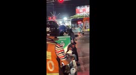 Pet cat sits on delivery rider's motorcycle food box