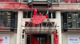 Activists from the group Palestine Action climb on the entrance of Allianz offices in the City of London