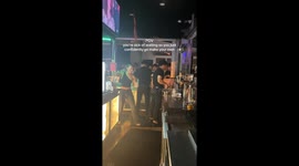 Woman waiting for ages at bar climbs over and makes herself a drink