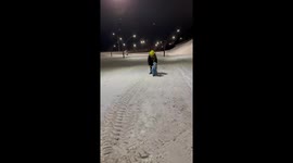 Monkey in baby clothes falls while walking on snow in Russia