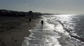 A metal prospector, against the light, searches for precious objects along the beach of Lido di Ostia on a beautiful March day in Rome.