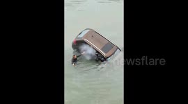 Heroic man and son-in-law dive into river to rescue drowning driver by smashing car windows