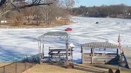 Cars Drive Down Frozen Fox River