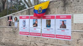 The Ecuadorian flag and signs reading ‘Urgent’ and ‘Forced Departure’ and photos of some people hanging on the wall during the demonstration ‘women of the world in struggle’ in Rome.