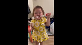 Little girl chooses to play with bubble blower despite no bubbles
