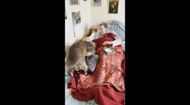 Elderly woman with dementia filled with joy as friendly dog greets her