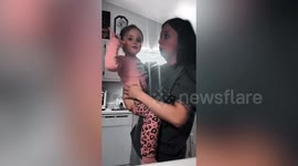Toddler tries to stop mum from crying by sticking a pacifier in her mouth