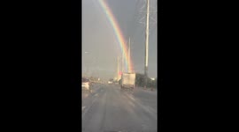 Rainbow illuminates sky over motorway in Philippines