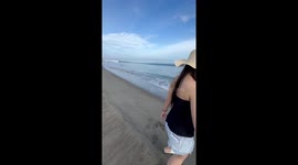 Beachgoer's video crashes when wave knocks her over