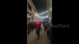 Syria: Syrian security forces marching through the streets of Homs