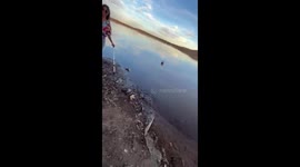 Man Uses Folding Chairs To Cross Water