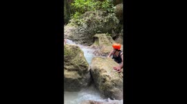 Canyoneer struggles with the white water current on adventure course