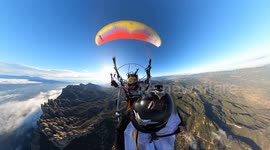 Wingsuit flyer glides through mountain hole in Barcelona, Spain