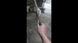 Dog playfully interacts with owner holding knife in Guangxi, China