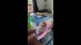 Dad gently taps baby to sleep but baby isn't in the mood yet