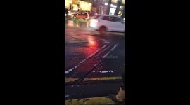 Jeep driver blows tire after failing to avoid massive pothole while driving in rain