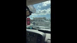Truck Drags Tree Down Road