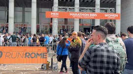 Participants in the Rome Marathon line up to collect their bibs and gadgets at the Expo Village at the Palazzo dei Congressi in Rome.