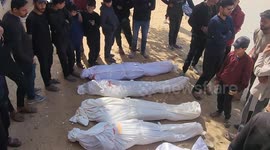 Mourners gather around the bodies of victims killed by Israeli bombardment, wrapped in white shrouds, in Beit Lahia, northern Gaza Strip, outside the Indonesian hospital on March 15, 2025. Gaza's civil defense agency reported that nine people, including j