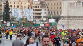 Runners pass the construction site of the new Piazza Venezia Metro C station during the Acea Run Rome The Marathon in Rome.