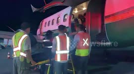Medic carry Honduras plane crash survivors back to mainland