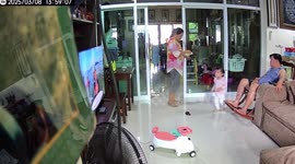 Curious toddler swings on table causing it to topple onto her