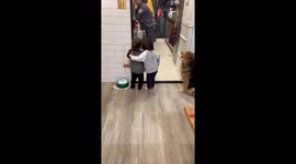 Twin comforts younger brother while their mother cooks in Taiwan