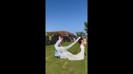 Wind blows bride's veil and it lands directly on bridesmaid’s head