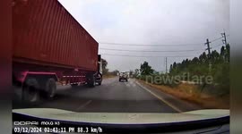 Piece of plywood flies into car travelling behind on road in Thailand