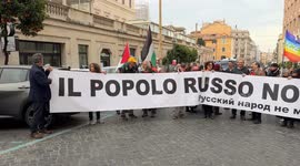 Protesters hold up a large banner with the slogan 'the Russian people are not my enemy' during the demonstration to say no to rearmament called by left wing movements in Rome.