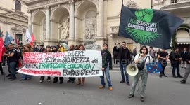 Protesters hold up a banner reading 'Earthquakes and floods... the real emergencies are securing the territories and ecological transition! eco-resistance' during the demonstration to say no to rearmament called by left wing movements in Rome.