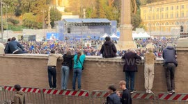 Spectators at the top of the barriers to watch from the top of the walls of Piazza del Popolo, full of people, the demonstration ‘A Square for Europe’ promoted by journalist Michele Serra in Rome.