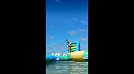Beachgoer takes a tumble off inflatable waterslide
