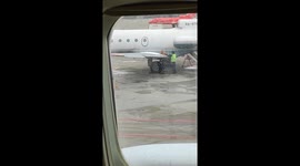 Airport employee uses traffic cone to clear ice from plane in Vnukovo, Russia