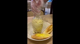Waiter struggles to serve pasta out of a wine glass