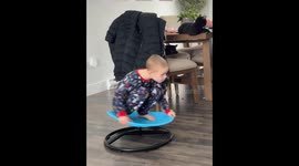 Child Whirls Around On Spin Chair