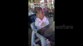 Little girl sticks middle finger up as restaurant sings happy birthday to her
