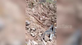 Backhoe operator rescues puppy in burrow while clearing garbage