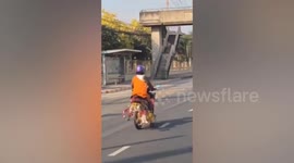 Motorcyclist in Buddhist monk robes arrested for riding with python on shoulder