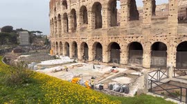 Workers at work on the construction site in front of the external area of the Colosseum in Rome.