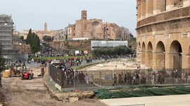 Tourists exit the Colosseum along the cordoned off walkways due to construction work in the construction site in front of the external area of the Colosseum in Rome.