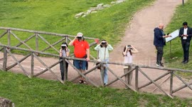 Tourists wearing immersive headsets with see-through augmented and virtual reality technology take a virtual tour of ancient Rome at the Circus Maximus in Rome.