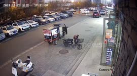 Wind blows electric tricycle across road... perfectly slotting it into parking space
