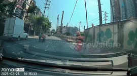 Motorists help a rider pick up his fallen belongings on the highway