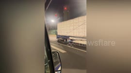 Small truck speeds down motorway with oversized cargo two times its length