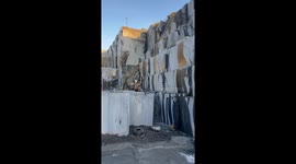 4K video of from a quarry in Larvik, Norway. Real natural stone, amazing and satisfying view of a gigant slab pulled over with a wheelloader from Volvo.